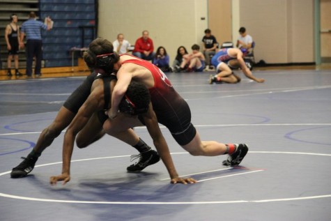 Coppell High School sophomore Hudson Brock (red) wrestles against Coppell wrestler freshman Josh Williams (black) in the navy gym at Flower Mound High School. The JV wrestling team competed in the District 6 JV Championships Wednesday. 