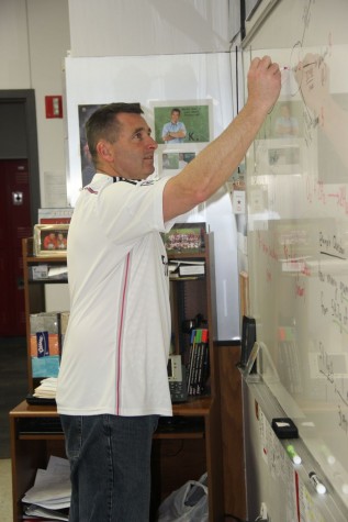 Coppell High School chemistry teacher Chris Stricker helps students better their education during class on Friday. Stricker was a former soccer coach and retired that position last year after winning the Cowgirls won state.
