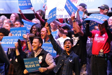 Supporters of presidential candidate Bernie Sanders cheer after Sanders stated his plans to raise minimum wage and his ideas to create a free college tuition for the future of America. Attendees gathered at the Verizon Center in Grand Prairie on Feb. 27 to show their support. Photo by Amanda Hair. 