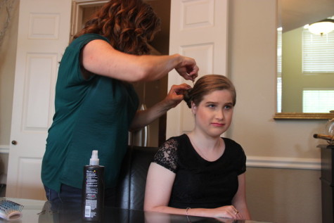 Coppell High School junior Ashton WIlliams has her hair done by her mother on Saturday in her home. Williams attended the CHS Spring Fling banquet, an evening celebrating the accomplishments of students who receive special education in the district. Photo by Mallorie Munoz