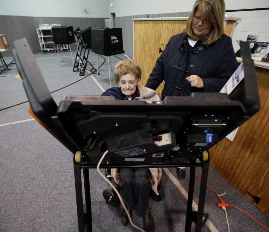 Jodie Kinney, 46, watches over her mother, Sandra Moler, 73, as she votes at one of the polling places for Dublin, Ohio, residents on Tuesday, November 2, 2010. (Courtney Hergesheimer/Columbus Dispatch/MCT)