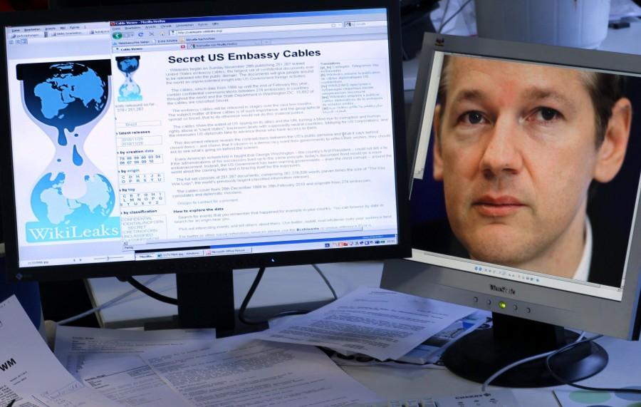 Two monitors show the website of Wikileaks with published confidential dispatches of U.S. diplomats (left) and a portrait of the founder of Wikileaks Julian Assange in Schwerin, Germany on November 30, 2010. Visa says it has suspended all payments to WikiLeaks pending an investigation of the organizations business on the same day that  WikiLeaks founder Julian Assange handed himself in to British police on Tuesday, December 7, 2010, after Sweden issued a warrant for his arrest over allegations of sex crimes. (Jens Buettner/Abaca Press/MCT)