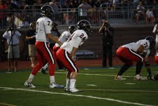 Quarterback Jake Larson, flanked by running back Luke Jenner, get ready to run a play against the Jesuit Rangers on Friday, September 9th. Larson and the Cowboys pulled off a win on a last second interception. 