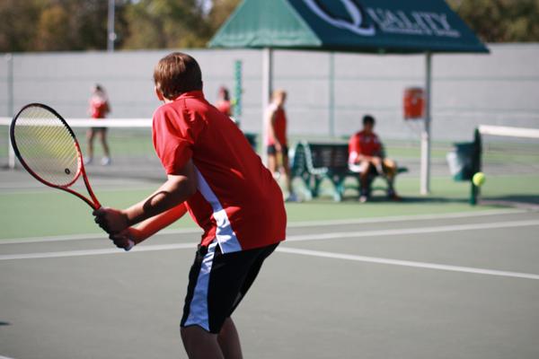 Senior Austin Jennings and fellow tennis members practice at the tennis center at Coppell High School. The tennis center is open every day for students to use. Photo by Brian Hwu. 