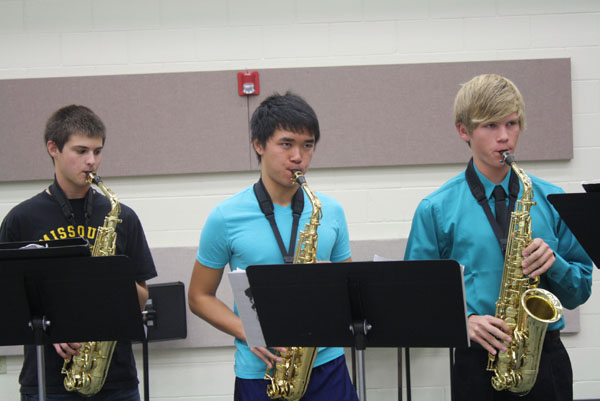 Band members Matt Smith, Ben Marshall, and Stephen Arifin practice the saxaphone before school in the band hall. Photo by Ivy Hess.  