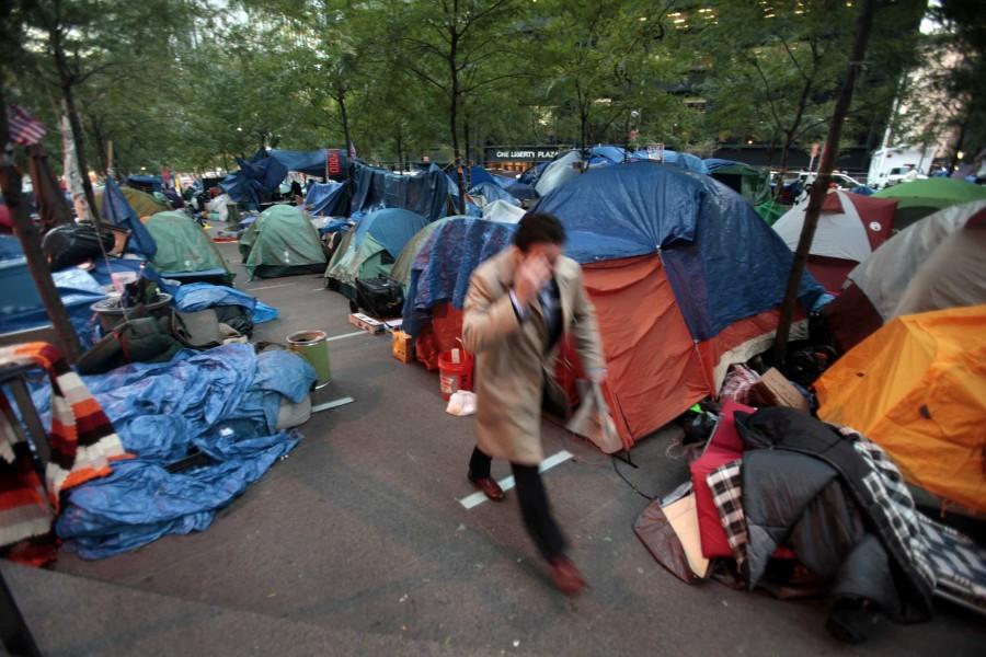 A man heads to work through the Occupy Wall Street camp in Zuccotti Park in New York City, Friday, October 28, 2011. As tempretures drop, some protesters at Occupy Wall Street attempt to stay warm inside tents. (Carolyn Cole/Los Angeles Times/MCT)