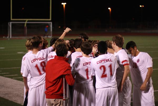 The Cowboys cheer on each other before going onto the field against the Plano Wildcats at the soccer scrimmage on Friday night. Coppell won the exhibition match 5-0. Photo by Brian Hwu.