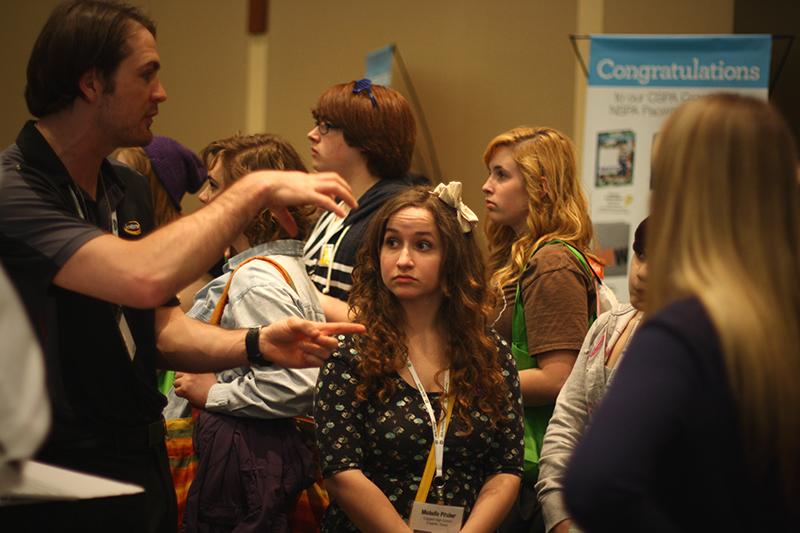 Editor-in-chief Michelle Pitcher listens as a spokesperson from Jostens speak about a new program that allows communities to share photos at the JEA/NSPA Spring National High School Journalism Convention on April 12. Photo by Brian Hwu.