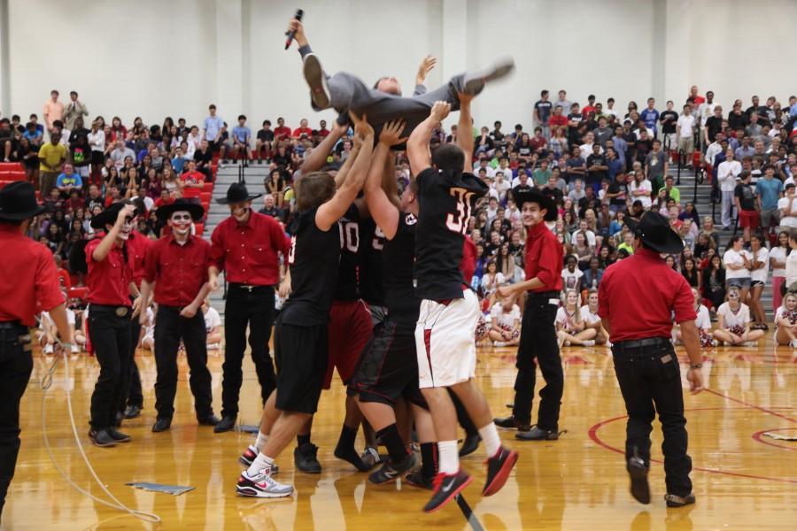 Coppell+football+players+take+down+the+Allen+Eagle+at+Fridays+pep+rally