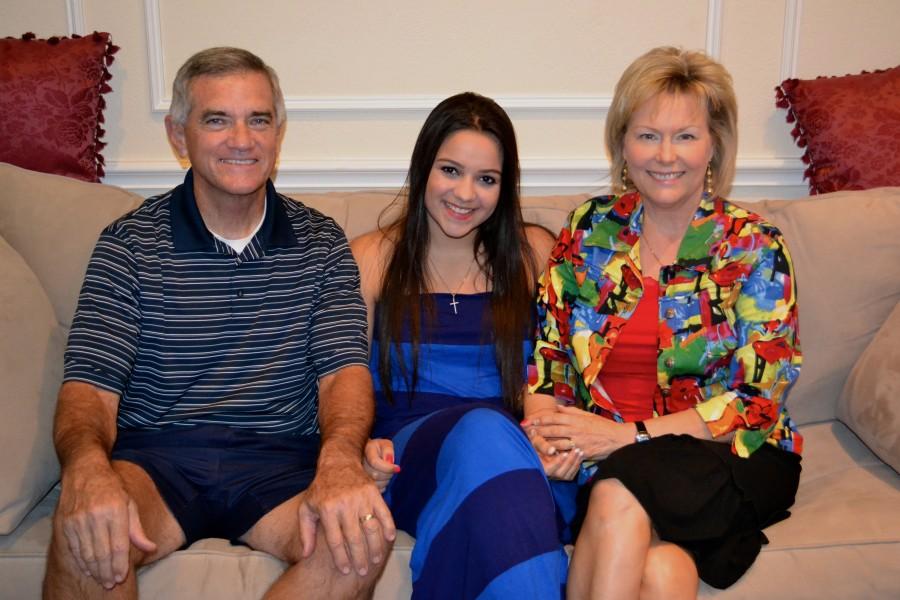 Foreign exchange student Carolina Salviato from Brazil smiles with her host parents Bob and Marilyn Barnett. Photo by Caroline Carter. 