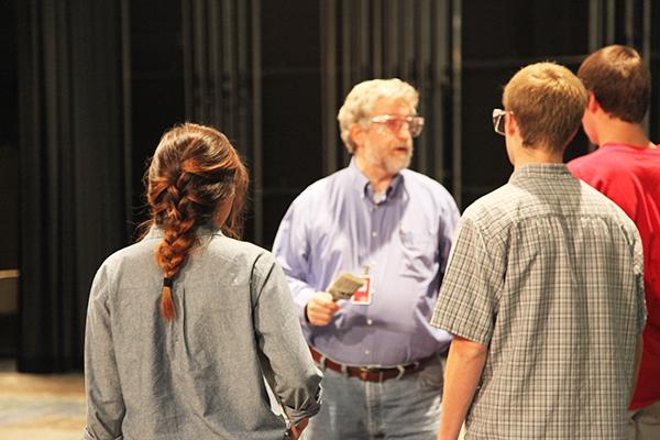 Theatre teacher Bill Ballard gives the students instructions on how to paint parts of the sets for the Coppell theatre production The Drowsy Chaperone. Photo by Rinu Daniel.