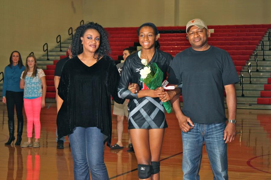 Senior Chiaka Ogbogu received flowers from her parents and took photos on the volleyball court in honor of senior night. Photo by Regan Sullivan.