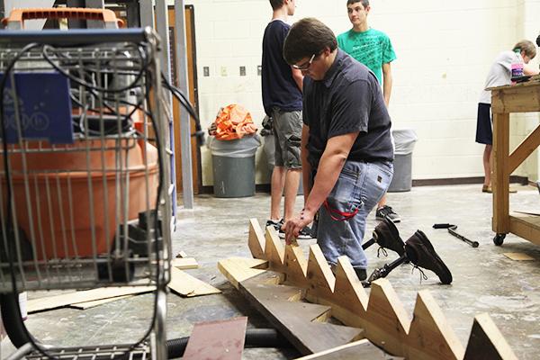 Senior Hollis Muenster works hard on a set piece for the production The Drowsy Chaperon. Hard work goes into the building of the sets for Coppells theater productions. Photo by Rinu Daniel.