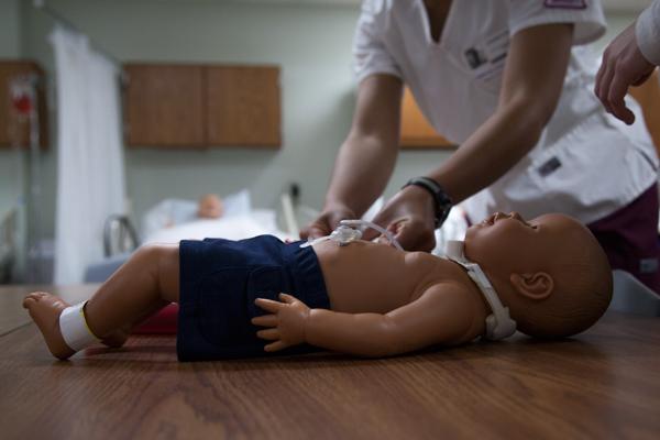 TWU and PSA students give blood and oxygen to an infant in hypothalamic  shock and elevated respiratory distress. Photo by Lauren Ussery.