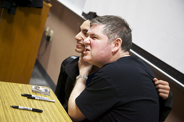 Jan. 30, After freshman Nick Jones gets his book signed, he asks author Darren Shan if he could get his photo taken with the premier horror and fantasy fiction writer. Before the book signing, Shan spoke to both Coppell High School students and the Coppell ISD middle school students that gathered in the lecture hall to hear his presentation and ask questions on Wednesday. Shan is well known for writing The Saga of Darren Shan series as well as his Cirque Du Freak series. Photo by Rowan Khazendar.
