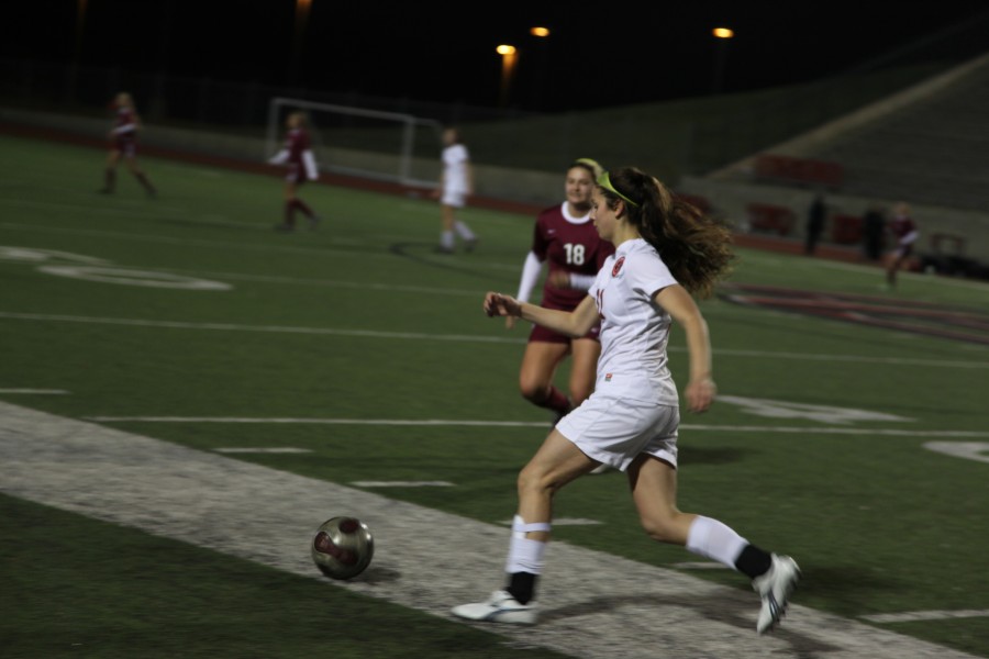 Junior+defender+Evan+Ross+advances+the+ball+up+the+field+in+the+Cowgirlss+final+home+game+against+Lewisville.+The+Cowgirls+have+since+advanced+to+the+Area+Round+of+the+2013+UIL+State+playoffs.+Photo+by+Rowan+Kazendar.