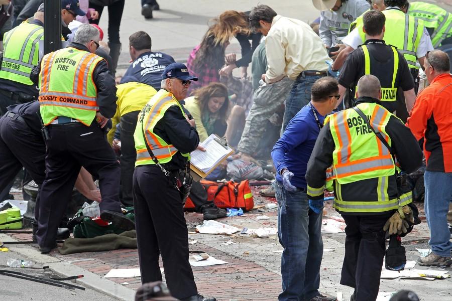 Emergency personnel assist the victims at the scene of a bomb blast during the Boston Marathon in Boston, Massachusetts, Monday, April 15, 2013. (Stuart Cahill/Boston Herald/MCT)