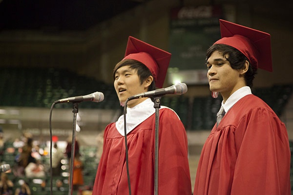 The Blanders, a cover band consisting of two individual singers and CHS graduates, Christian Van Hoose and Hanuy Kim sing “Somewhere Only We Know” at the 2012 CHS graduation ceremony last June at the University of North Texas coliseum. Van Hoose attends the Brigham Young University in Idaho and Kim attends the University of North Texas in Denton. Photo by Rowan Khazendar.