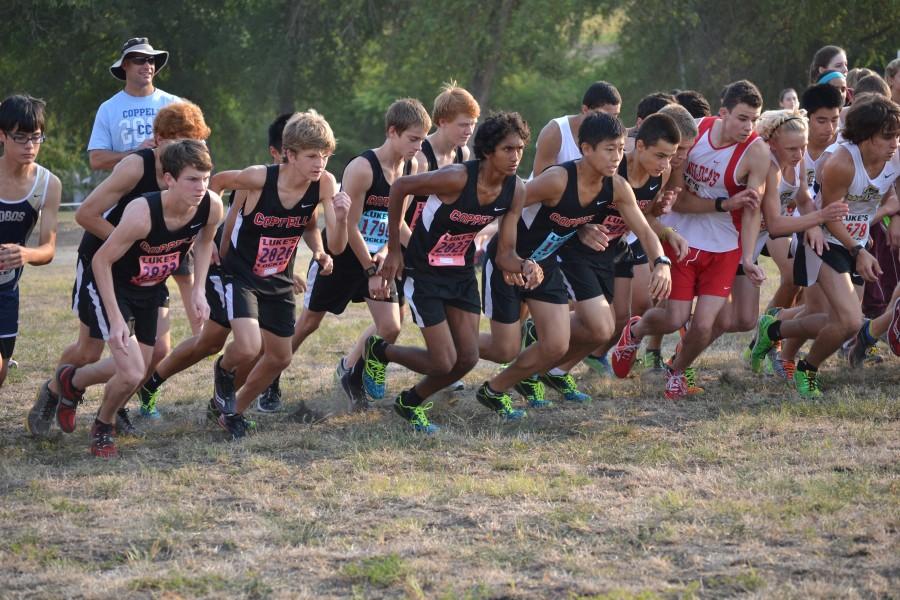 The Varsity boys team charges from the starting line at the Prosper Invitational. Photo by Elizabeth Sims.