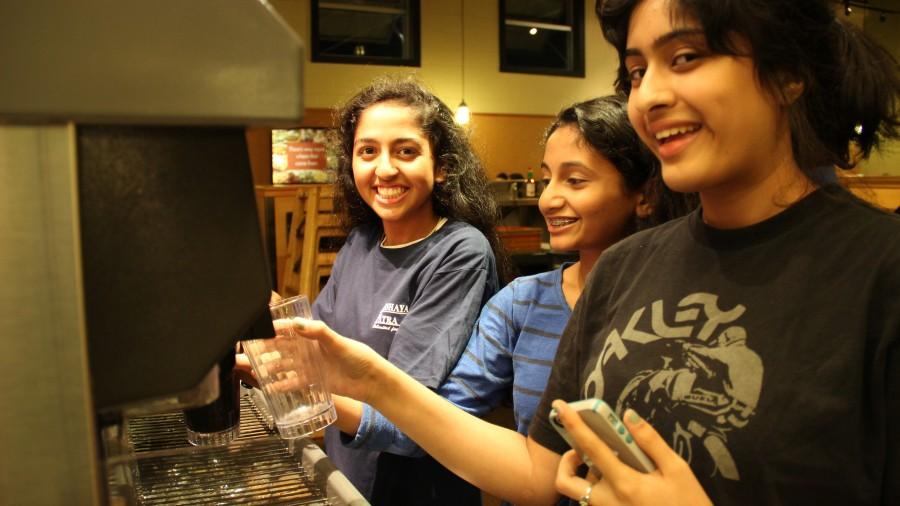 Sophomore and member Manali Gore and sophomores Sneha and Karkala and Veena Suthendran getting drinks at the Sweet Tomatoes event. Photo by Pranathi Chitta