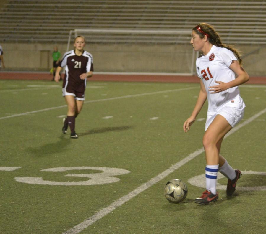Junior forward, Sarah King, carefully drives the ball down field, before taking a shot on goal. 
