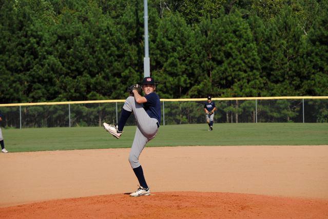 Sophomore Charles King winds-up to deliver a pitch during one of his travel team games