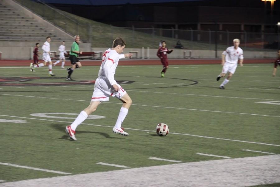 Senior Midfielder Neal Tatum dribbling the ball up field. Photo By Shannon Wilkinson