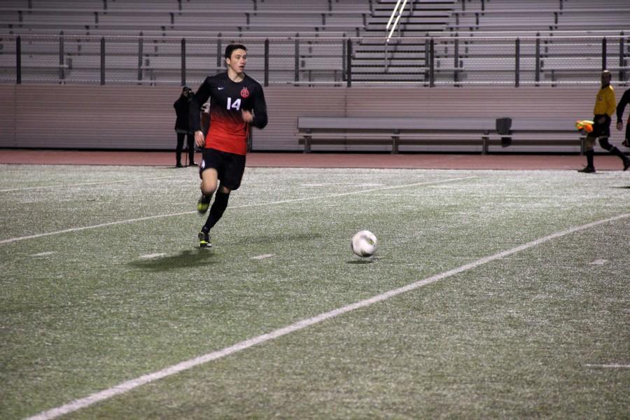 Senior defenseman Kellen Reid controls the ball in the Cowboys March 7 matchup against Flower Mound Marcus. Coppell finishes its regular season versus Lewisville on March 21. Photo by Shannon Wilkinson.