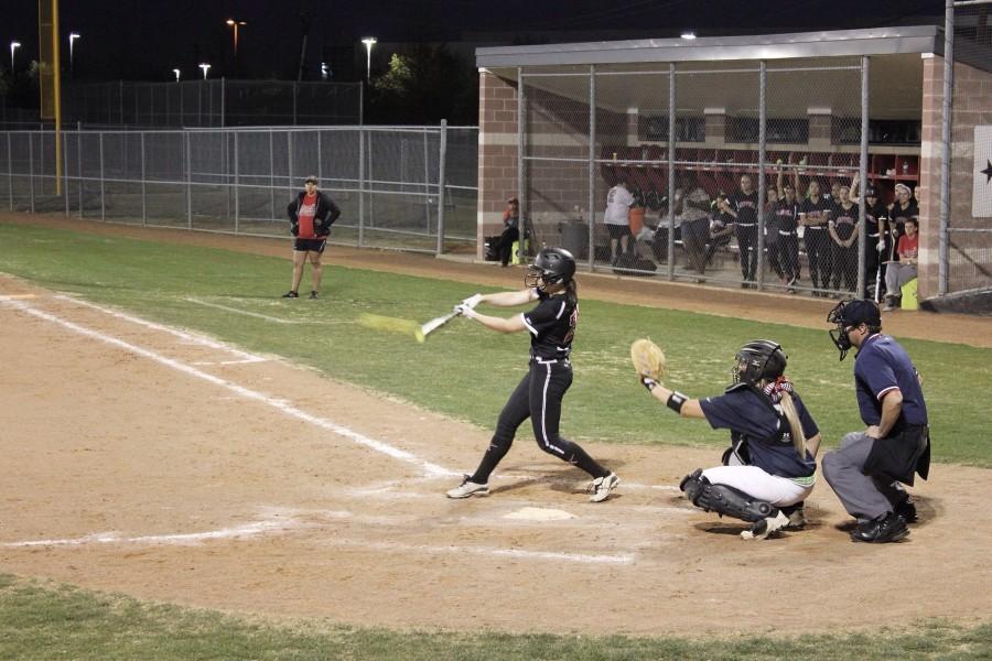 Sophomore outfielder Ali Gentry hits hard against rival Lewisville. Photo by Mark Slette.