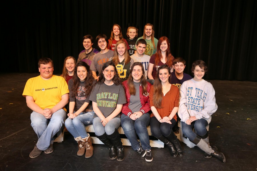 Senior theater students pose with their college t-shirts on the Coppell High School stage.