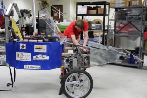 The Coppell High School solar car, which was raced over the summer, stays in STEM coordinator Mike Yakubovsky room, while Stephen Bavousett works on improving it for team’s next race.