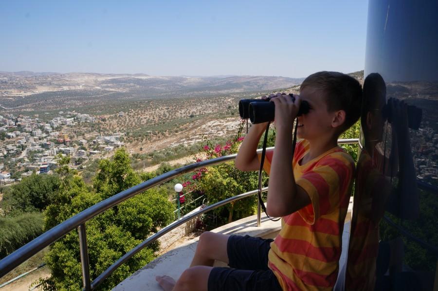 Coppell Middle School North eighth grader David Trakhtengerts sits on a friends balcony overlooking the city of Ariel in Israel. Photo courtesy of Natasha Livshits. 