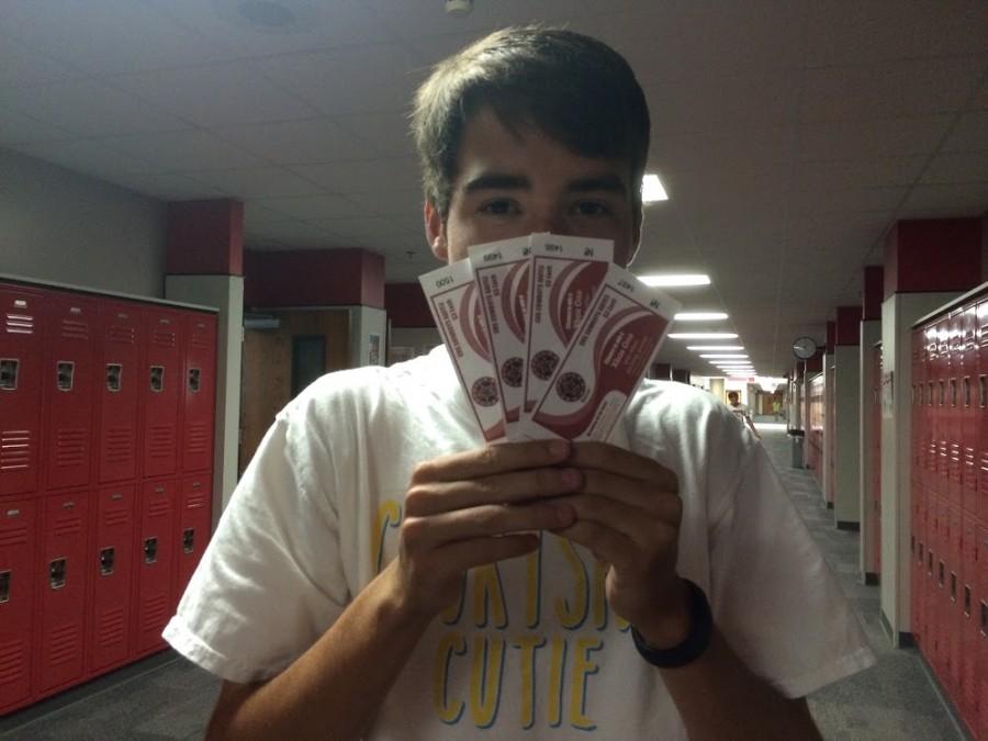 Varsity Soccer player, Jake Shumate with raffle tickets. 