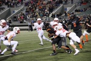 Junior Dillon Rainbolt (32) tackles the ball carrier for Haltom at the last District game on Friday night. The Cowboy’s defense only allowed the Haltom Buffalos six total first downs. Photo by Kelly Monaghan.