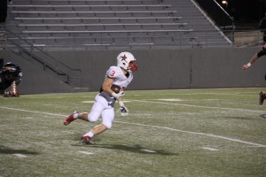 Junior Tanner Traw (3) evades Haltom defenders after a botched extra point in the third quarter at Friday night’s game against the Buffalos. The wide receiver was able to reach the end zone for the two point conversion on that play.