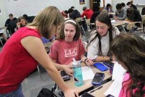 Mrs. Kosh takes time to help and answer the questions of some students regarding their worksheet, during her second period class on November 7, 2014. Photo by Amanda Hair