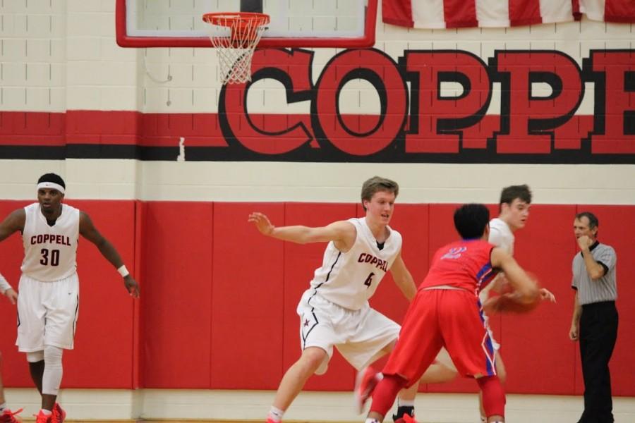 Sophomore Sam Marshall guards a Grapevine player in last nights game at Coppell High School. Marshall lead the team in scoring with 11 points. Photo by Kelly Monaghan.