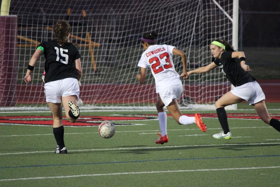Freshman Mckenzie Mcfarland charges toward the goal at Wednesday night’s game against Southlake Carroll. The Cowgirls won 2-1 at home. Photo by Kelly.