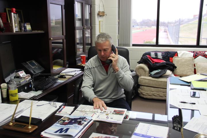 Athletics director John Crawford works in his office in the field house at Coppell High School on Feb. 20. Crawford has been at Coppell for 11 years. Photo by Kelly Monaghan.