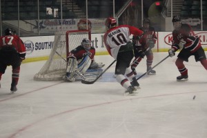 Sophomore captain James Reaman fights for the goal against Frisco in their playoff game loss. Reaman, who had 31 points (goals plus assists) in the 18 regular season games he played, had zero points in the game. Photo by Kelly Monaghan.