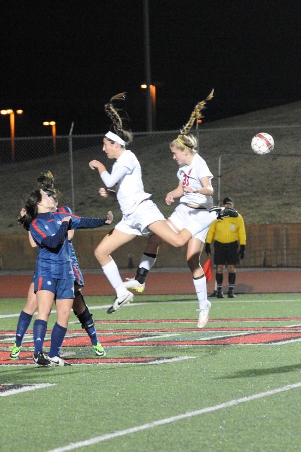 Senior Sarah King and junior Shay Johnson go up for a header off a Cowgirl corner kick during Coppell’s 5-0 win over the Richland Lady Raiders at Buddy Echols Field. Photo by Sarah VanderPol.
