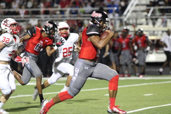 Coppell High School seniors Dylan Rainbolt (left) and Kyran Jamison (right) chase after Cedar Hill junior Avery Davis during the second quarter, with a score of 13-0, the Longhorns taking the lead. The Cowboys later scored three touchdowns, but still could not beat Cedar Hill on Friday night. Photo by Amanda Hair.