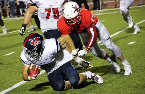 Junior outside linebacker Cody Masters brings down the ball carrier in the fourth quarter of Coppells win over Boyd.In the fourth quarter, McKinney Boyd scored two touchdowns, but it wasn’t enough to pull out a win, as Coppell won with an end score of 34-14 on Friday night’s game. Photo by Amanda Hair. 