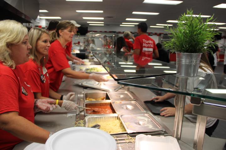 

Lariette parents and volunteers serve out the spaghetti from Bistecca in the cafeteria Friday night before the football game. The Lariette Spaghetti dinner is an annual fundraiser with raffle prizes, baked goods and a silent auction. Photo by Aubrie Sisk.
