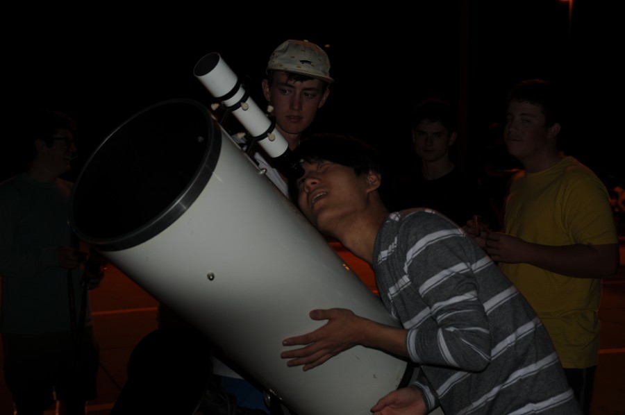 Coppell High School senior David Kim looks through Angela Barnes’ reflector telescope named Beast to view the moon during the star party on Wednesday. “Although it’s only a sliver, you can see all of the textures on the moon,” Kim said. “It’s completely insane.” Photo by Alexandra Dalton.
