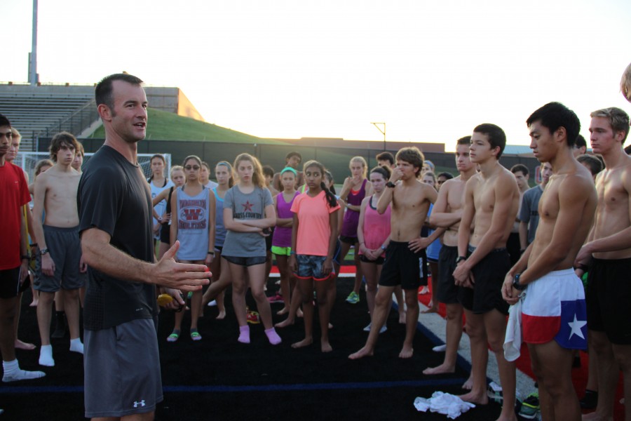 Coppell High School cross country coach Nick Benton instructs the team after running a time trial early Saturday morning at Buddy Echols Field. The varsity team is preparing for a meet on Saturday in Round Rock. The junior varsity team is attending the Jesuit Invitational. Photo by Jennifer Su. 