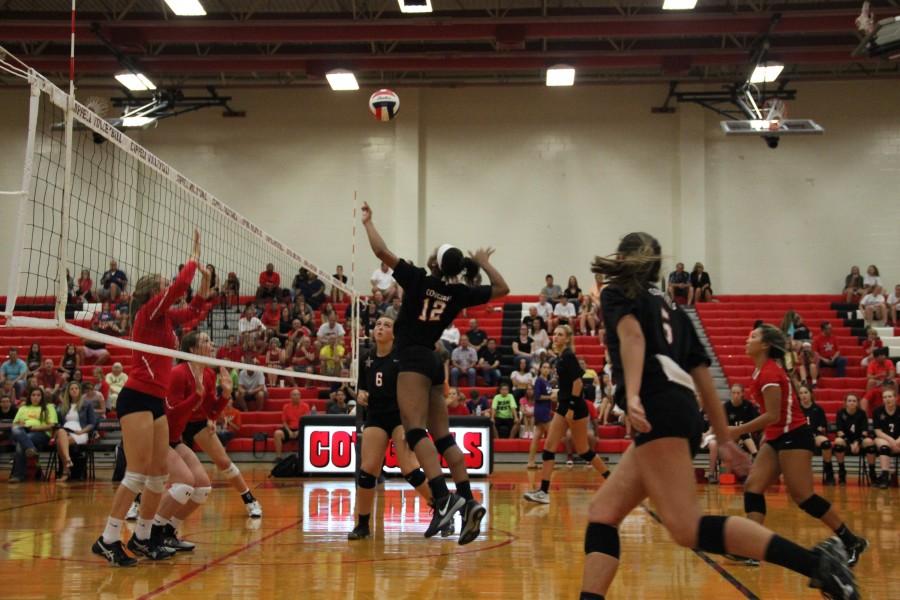 Coppell High School freshman middle blocker Mykayla Myers scores during the volleyball game on Sept. 4. The Cowgirls played the Grapevine Mustangs at Coppell High School and won 25-13, 25-13 and 25-20.