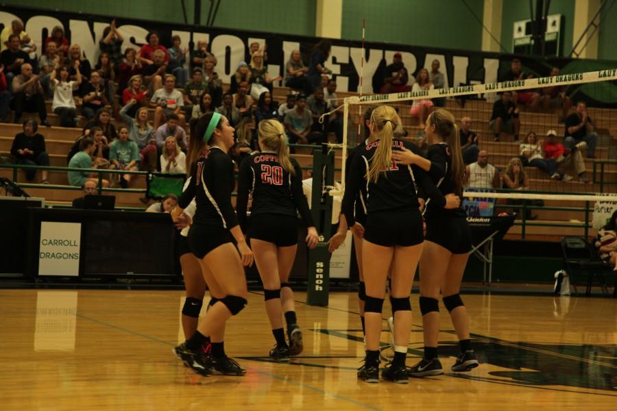 Coppell High School Cowgirls celebrate a kill against the Southlake Dragons during the final volleyball game which decides their district ranking on Oct 27 at Southlake High School. The Dragons took the lead and gained the district title. Photo by Aubrie Sisk.