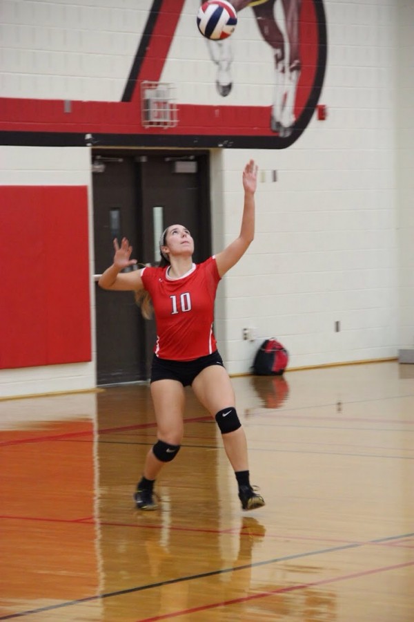 Coppell High School senior Caroline Riley serves the ball to begin the set against the Trojans. The Cowgirls won all three sets, the first with a score of 25-9, 25-17, and 25-11 on Friday nights game in the CHS large gym. Photo by Megan Winkle.
