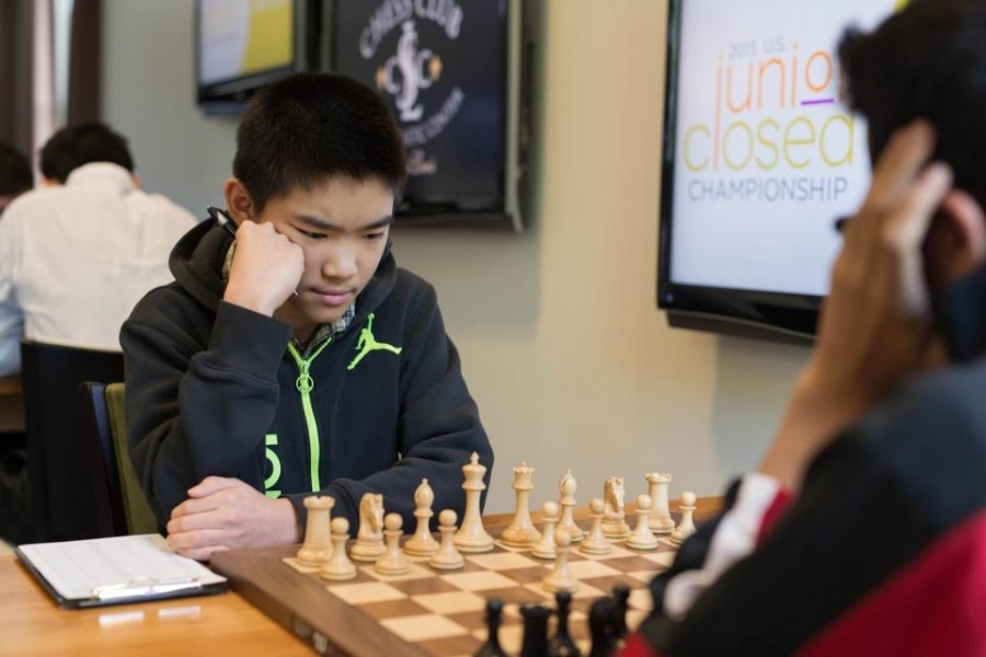 14-year-old chess medalist Jeffery Xiong contemplates his next move during the seventh round of the U.S. Junior Closed Championships in St. Louis. The match, played against 15-year-old Akshat Chandra was one of the most highly anticipated in the tournament. Photo courtesy Austin Fuller, U.S. Junior Closed Championships.
